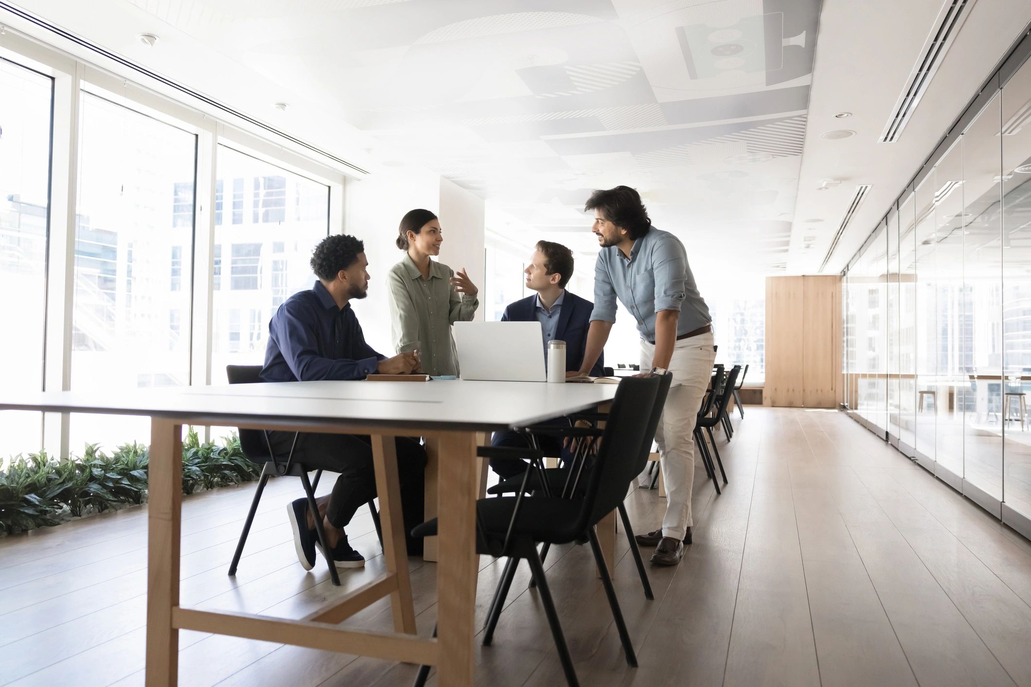 Coworkers discussing strategy at a meeting table